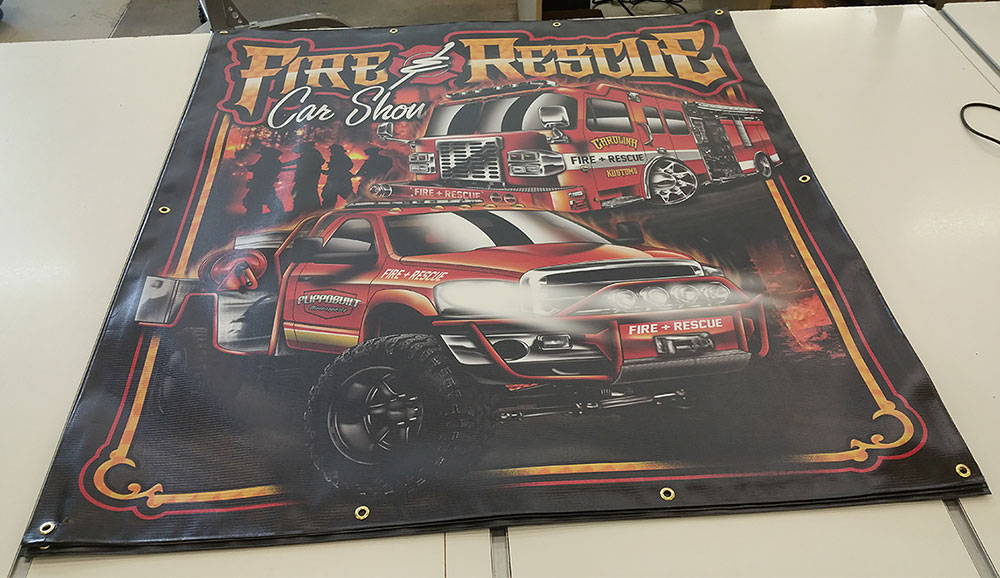 Banner for "Fire & Rescue Car Show" featuring illustrations of a fire truck and rescue vehicle on a flat white surface.